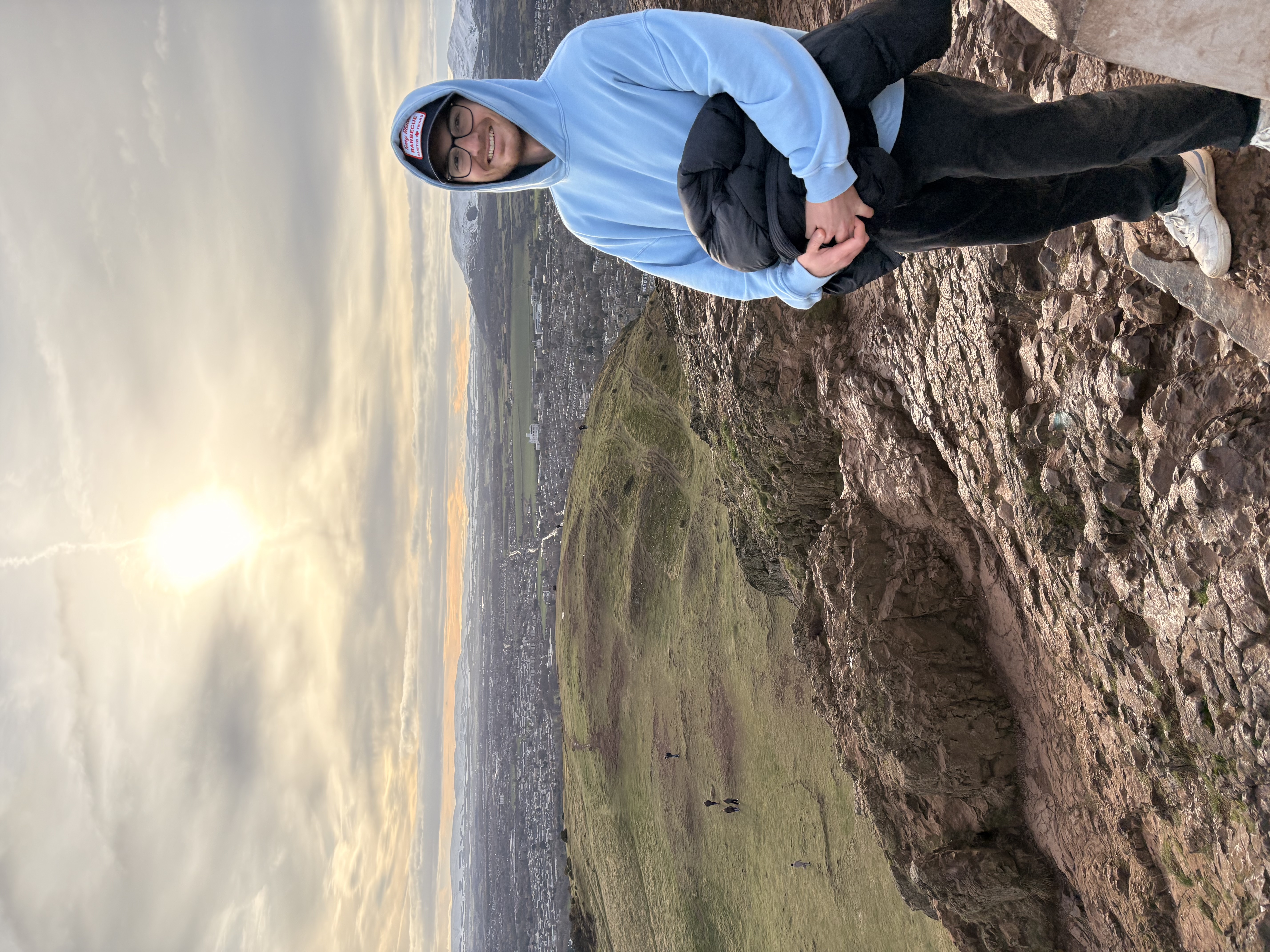 Me standing at the peak of Arthur's Seat in Edinburgh, Scotland
